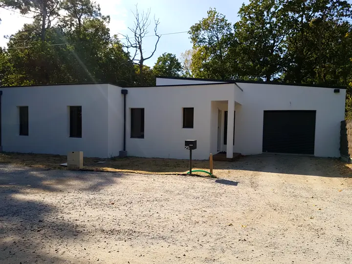 Maison à toit plat blanche avec garage